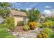 Back of home with lush landscaping and large trees at 625 Nighthawk Cir, Winter Springs, FL 32708