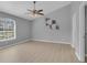 Bright bedroom featuring a ceiling fan, neutral walls, and wood-look floors at 625 Nighthawk Cir, Winter Springs, FL 32708