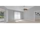 Bright bedroom features a ceiling fan, neutral carpet, and sliding glass doors to the outside at 625 Nighthawk Cir, Winter Springs, FL 32708