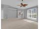 Bedroom with a ceiling fan, light gray walls, neutral carpet, and sliding glass doors at 625 Nighthawk Cir, Winter Springs, FL 32708