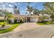 Charming single-story home boasts lush landscaping, a tile roof and screened entryway at 625 Nighthawk Cir, Winter Springs, FL 32708