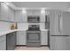 Updated kitchen with stainless steel appliances, light cabinets, and sleek countertops at 625 Nighthawk Cir, Winter Springs, FL 32708