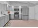 Updated kitchen featuring stainless appliances, tile floors, and modern cabinetry at 625 Nighthawk Cir, Winter Springs, FL 32708