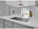 Bright kitchen featuring a stainless steel sink, a modern faucet, and a view to an outdoor patio at 625 Nighthawk Cir, Winter Springs, FL 32708
