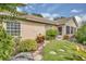 Beautifully landscaped side yard featuring lush greenery and decorative stone walkways at 625 Nighthawk Cir, Winter Springs, FL 32708
