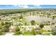 Expansive aerial view of a residential neighborhood featuring a tranquil lake and lush greenery at 7609 Winter Shade Dr, Orlando, FL 32822