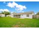 Grassy backyard, enclosed patio, and perimeter fence create a private outdoor space at 7609 Winter Shade Dr, Orlando, FL 32822