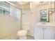 Clean bathroom with tiled shower, glass door, vanity, and white fixtures for a functional and modern style at 7609 Winter Shade Dr, Orlando, FL 32822