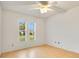 Bright bedroom features wood floor, ceiling fan, and double windows that fill the space with natural light at 7609 Winter Shade Dr, Orlando, FL 32822