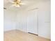 Bright bedroom features wood floor, ceiling fan, and double door closet, creating an airy, comfortable space at 7609 Winter Shade Dr, Orlando, FL 32822
