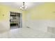 Bright dining room with white tile floors, yellow walls, and sliding glass doors to the outdoors at 7609 Winter Shade Dr, Orlando, FL 32822
