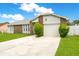Charming single-story home with stone accents, well-maintained lawn, and a two-car garage at 7609 Winter Shade Dr, Orlando, FL 32822
