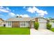 Charming single-story home with stone accents, a well-manicured lawn, and an attached garage at 7609 Winter Shade Dr, Orlando, FL 32822