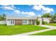 A charming single-story home with stone accents, a well-manicured lawn, and an attached garage at 7609 Winter Shade Dr, Orlando, FL 32822