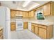 Bright kitchen featuring oak cabinets, white appliances, and ample counter space for meal preparation at 7609 Winter Shade Dr, Orlando, FL 32822