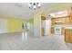 Kitchen with oak cabinets, white appliances, tile floors, and open layout to the dining area at 7609 Winter Shade Dr, Orlando, FL 32822
