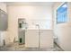 Clean laundry room with washer, dryer, and new water heater creating a bright space at 7609 Winter Shade Dr, Orlando, FL 32822