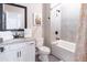 Bright bathroom showcasing a tub-shower combo, white cabinets, and a decorative shower curtain at 7951 Haverhill Way, Kissimmee, FL 34747