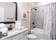 Bright bathroom showcasing a tub-shower combo, white cabinets, and a decorative shower curtain at 7951 Haverhill Way, Kissimmee, FL 34747