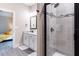 Modern bathroom featuring a tiled shower, granite countertop vanity, and neutral color palette at 7951 Haverhill Way, Kissimmee, FL 34747