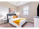 Well-lit bedroom boasts a comfortable bed and large window, creating a relaxing ambiance at 7951 Haverhill Way, Kissimmee, FL 34747