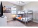 Cozy bedroom featuring a bunk bed, dresser, and mounted TV creating an efficient and comfortable space at 7951 Haverhill Way, Kissimmee, FL 34747