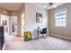 Neutral-toned bedroom showcasing a cozy study area with a desk, chair, and natural light at 7951 Haverhill Way, Kissimmee, FL 34747
