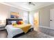 Inviting bedroom featuring a plush bed, soothing colors, and access to the adjacent bathroom at 7951 Haverhill Way, Kissimmee, FL 34747