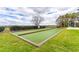 Outdoor bocce ball court with synthetic turf and wooden borders, located in a well-maintained community at 7951 Haverhill Way, Kissimmee, FL 34747