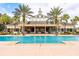 Resort-style community pool surrounded by palm trees, offering a relaxing and luxurious atmosphere at 7951 Haverhill Way, Kissimmee, FL 34747