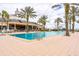 Large community pool area with a modern clubhouse, perfect for relaxing and socializing at 7951 Haverhill Way, Kissimmee, FL 34747