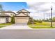 Charming two-story home with a well-manicured lawn, a two-car garage and a cozy, inviting facade at 7951 Haverhill Way, Kissimmee, FL 34747