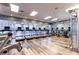 Well-equipped gym with modern treadmills, elliptical machines and weight-lifting equipment with wood-look flooring at 7951 Haverhill Way, Kissimmee, FL 34747