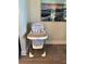 A babyjoy high chair with star pattern near a wall with framed art at 7951 Haverhill Way, Kissimmee, FL 34747