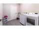 Laundry room with new side-by-side washer and dryer on dark wood-look flooring at 7951 Haverhill Way, Kissimmee, FL 34747