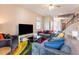 Comfortable living room with large sectional sofa, a flat-screen TV, and modern decor, creating a relaxing atmosphere at 7951 Haverhill Way, Kissimmee, FL 34747