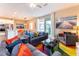 Bright living room with modern furniture, colorful decor and a sliding glass door to the outdoor patio at 7951 Haverhill Way, Kissimmee, FL 34747