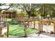 Beautiful mini golf course surrounded by trees, with stone accents and small waterfall at 7951 Haverhill Way, Kissimmee, FL 34747