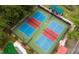 Aerial view of pickleball courts with blue and red playing surfaces and green exterior at 7951 Haverhill Way, Kissimmee, FL 34747