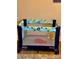 A Graco Pack 'n Play with toys inside is set up for toddler playtime at 7951 Haverhill Way, Kissimmee, FL 34747