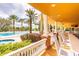 Poolside bar and seating area with view of pool, palm trees and manicured landscaping at 7951 Haverhill Way, Kissimmee, FL 34747