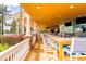 Poolside bar and seating area with bar seating and view of pool and palm trees at 7951 Haverhill Way, Kissimmee, FL 34747