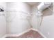 Spacious walk-in closet featuring metal shelving and plush carpeting, offering ample storage at 7951 Haverhill Way, Kissimmee, FL 34747