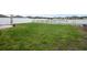 Expansive grassy backyard enclosed by a white picket fence, perfect for Gathering activities at 8615 N Rindge Rd, Polk City, FL 33868