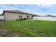 Large backyard featuring a well-maintained lawn, patio, and white vinyl fencing at 8615 N Rindge Rd, Polk City, FL 33868