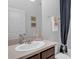 Clean bathroom featuring a vanity with a sink and a shower/tub with a blue curtain at 8615 N Rindge Rd, Polk City, FL 33868