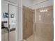 Modern bathroom shower with tiled walls and glass door, adjacent to bedroom at 8615 N Rindge Rd, Polk City, FL 33868