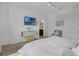 Bright bedroom featuring a TV, mounted decor, accent chair and ensuite bathroom at 8615 N Rindge Rd, Polk City, FL 33868