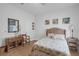 This bedroom offers wood-look flooring, neutral walls, and a decorative headboard at 8615 N Rindge Rd, Polk City, FL 33868