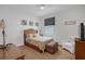 This bedroom offers wood-look flooring, neutral walls, a ceiling fan, and a decorative headboard at 8615 N Rindge Rd, Polk City, FL 33868